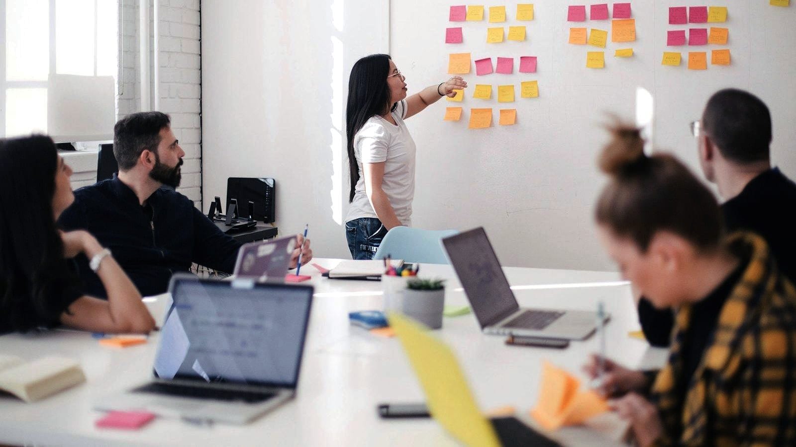 A team mapping a problem across a wall of notes