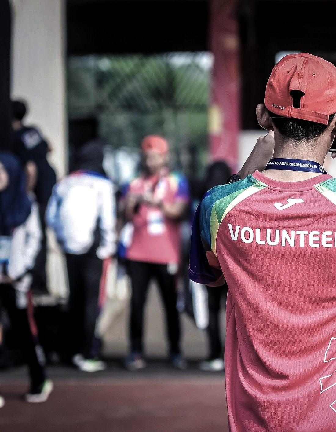 A volunteer in a marked shirt working at a community event