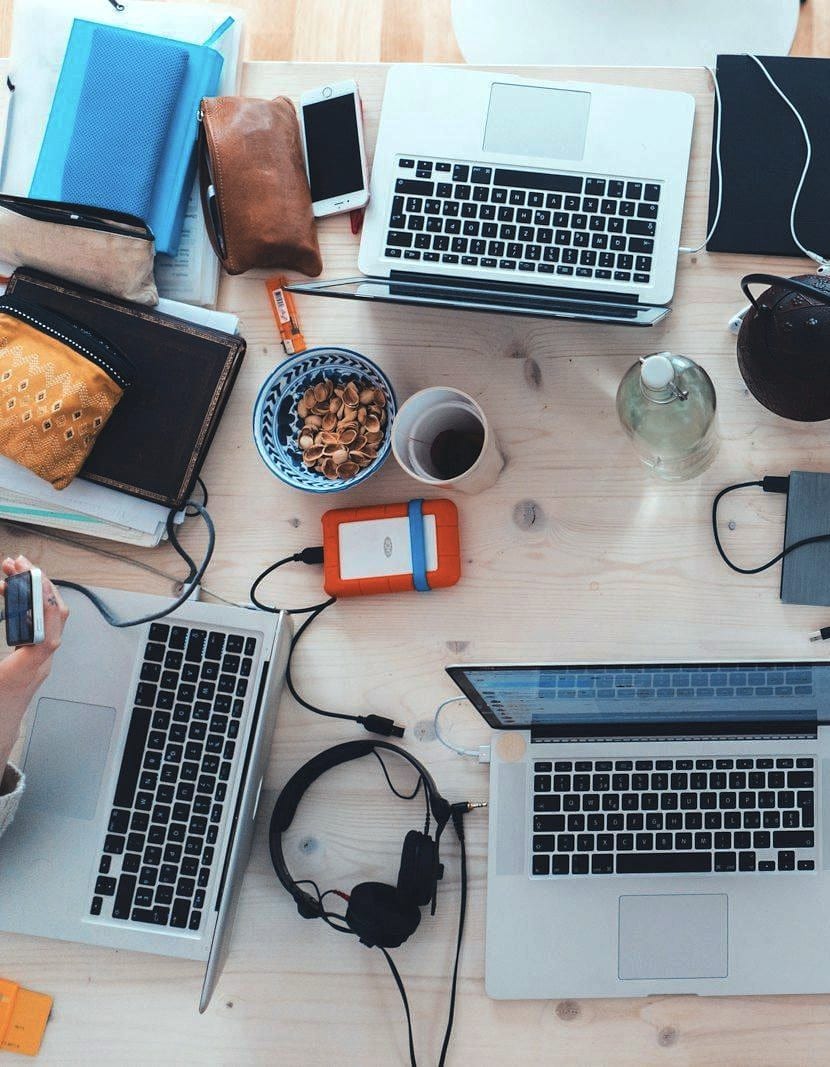 An overhead view of a shared working desk mid-project