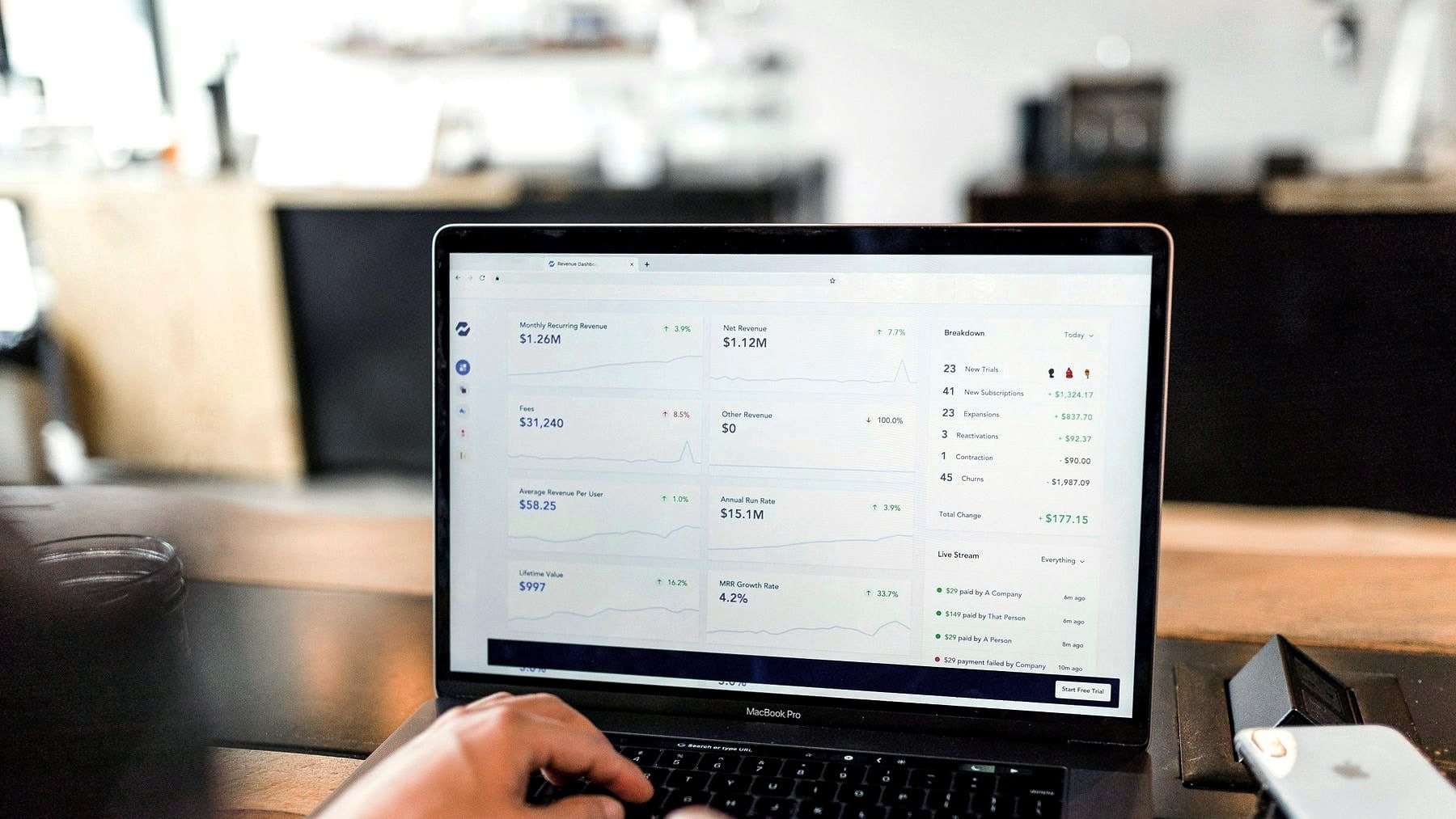 Hands working through an application interface on a laptop