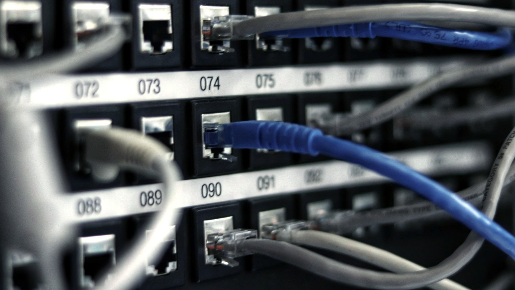 Numbered ports on a patch panel with cables run between them