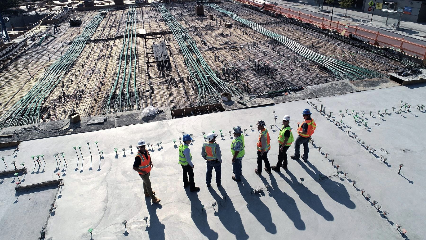 A construction site from above with the crew lined out across it