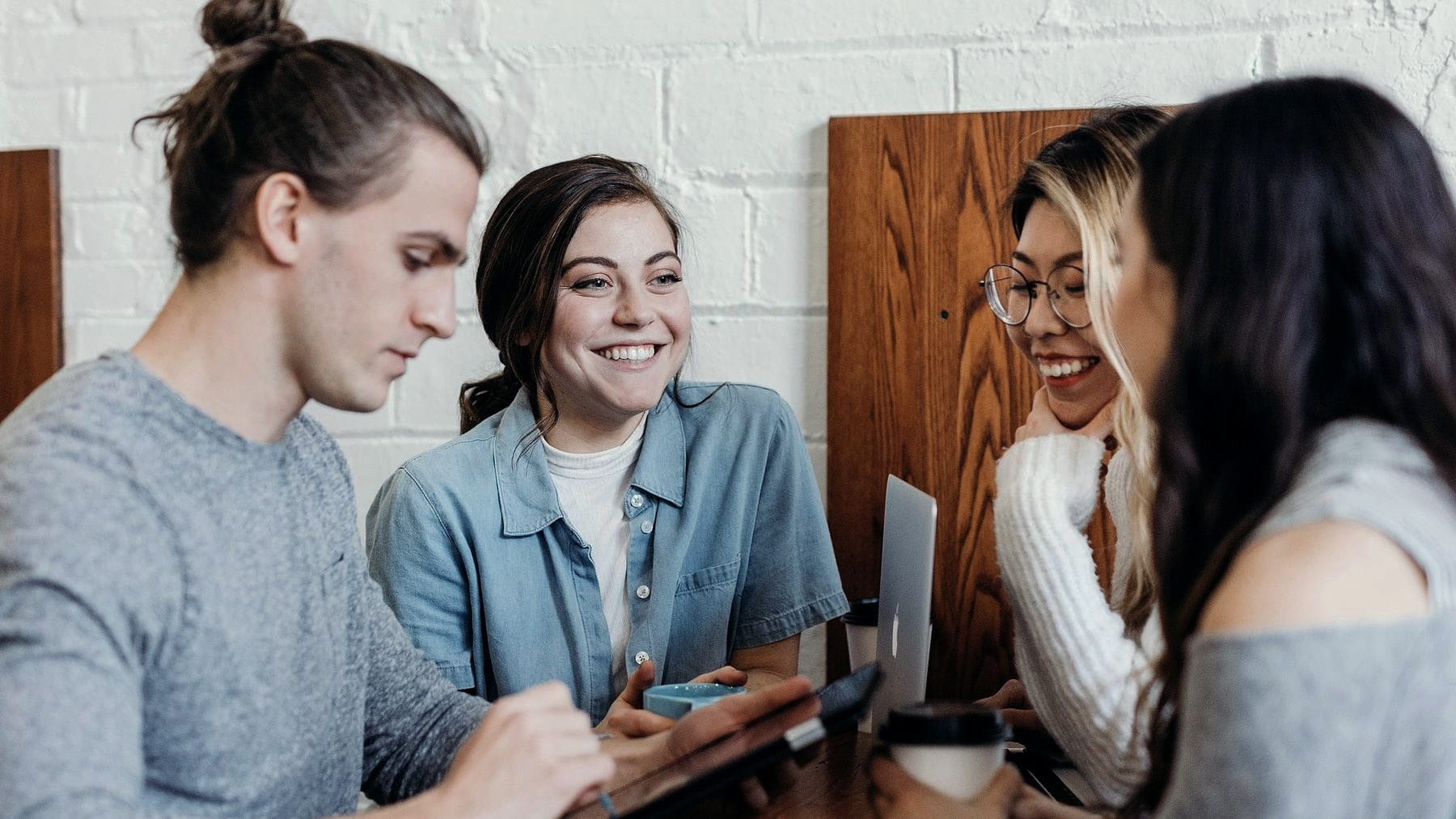 Four people talking something through around a table